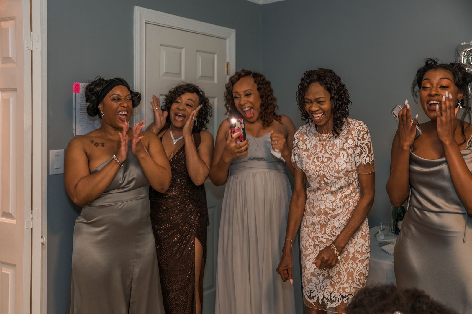Bridesmaids reacting to the bride