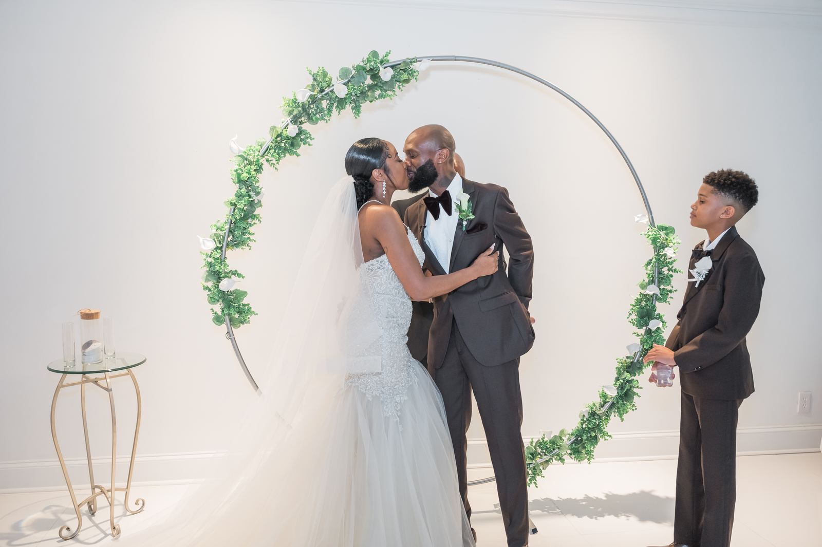 Anjanette and Ritchie kissing with their son