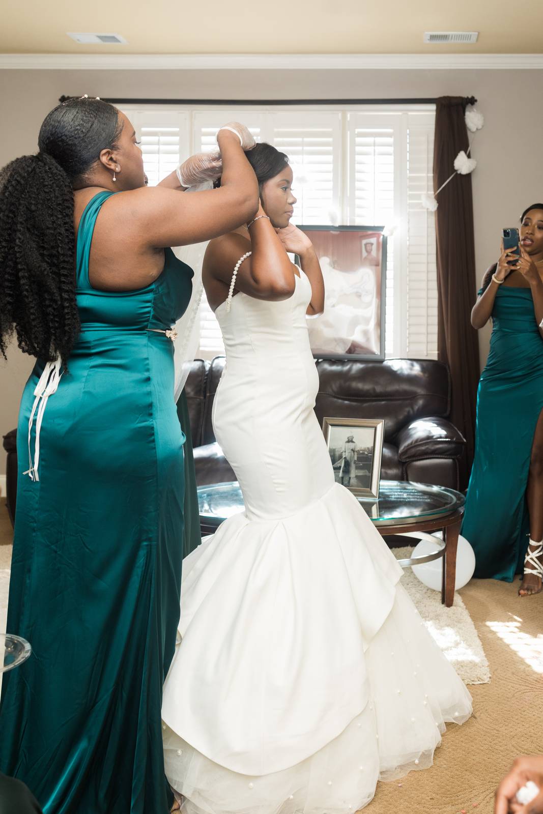 Christina's gown being zipped