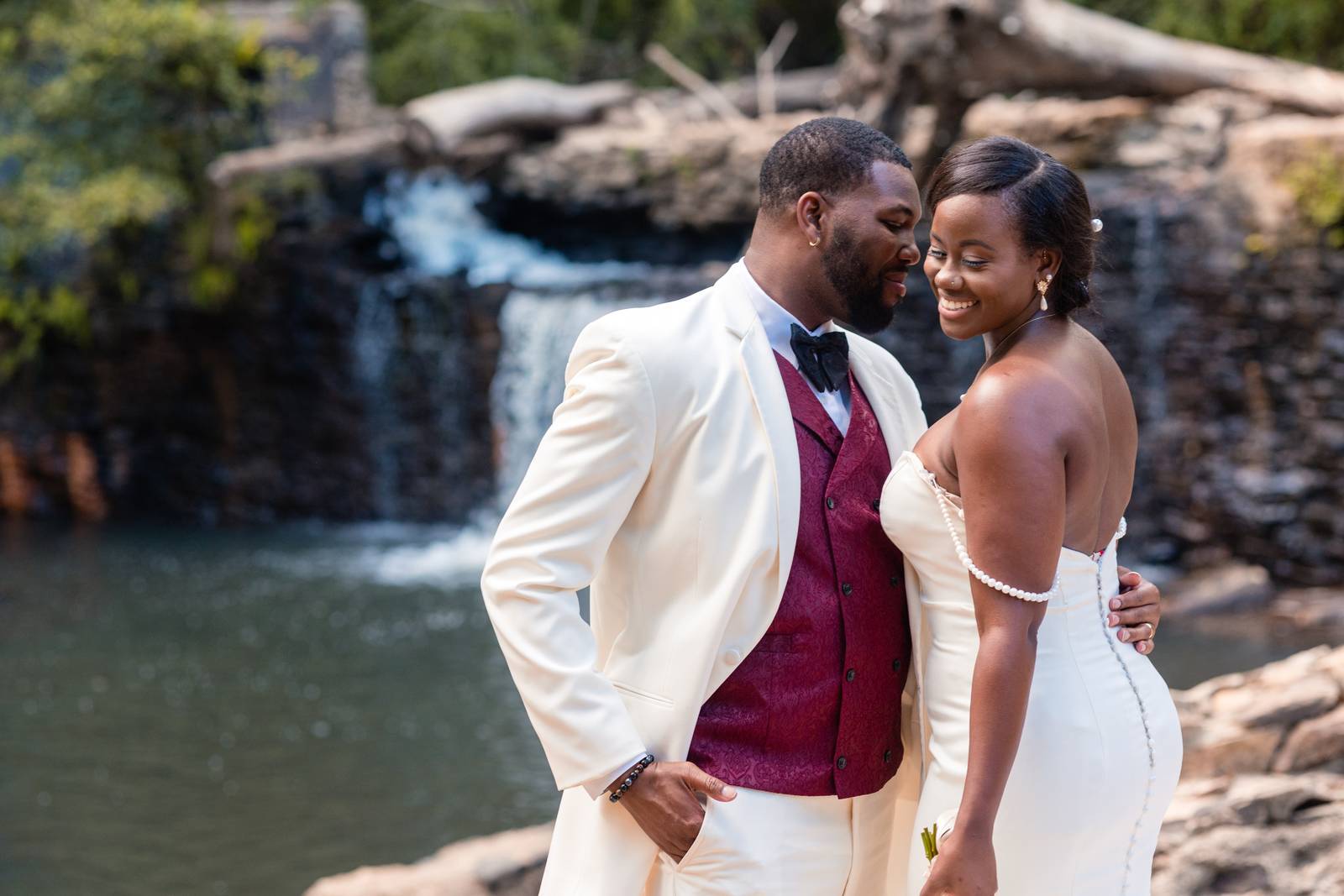Christina and Darius laughing by the waterfall