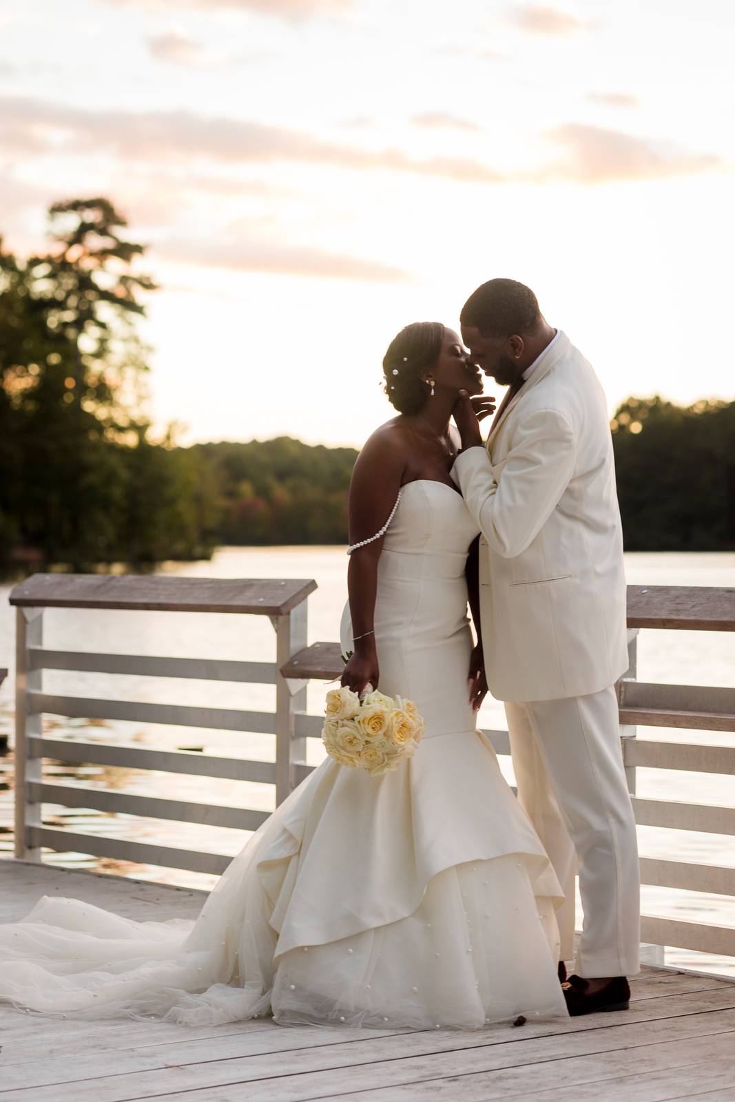 Christina and Darius kissing at sunset