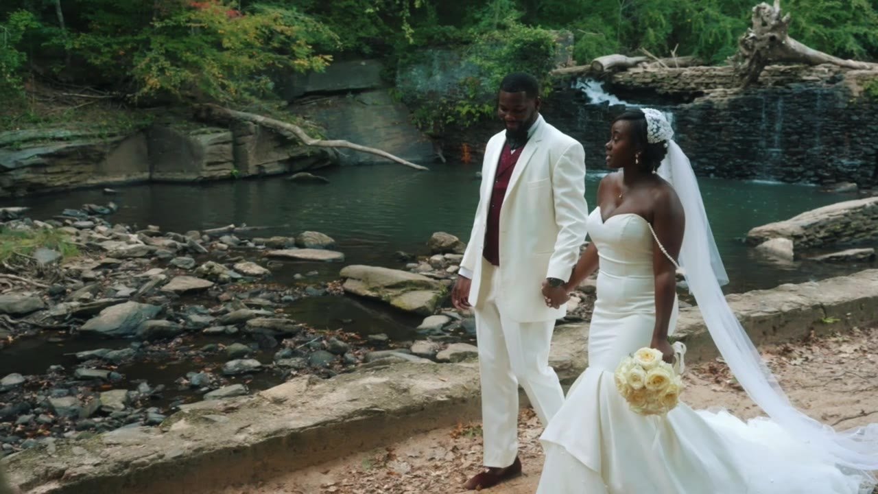 Still from the Christina and Darius highlight film: walking the rocks below the waterfall