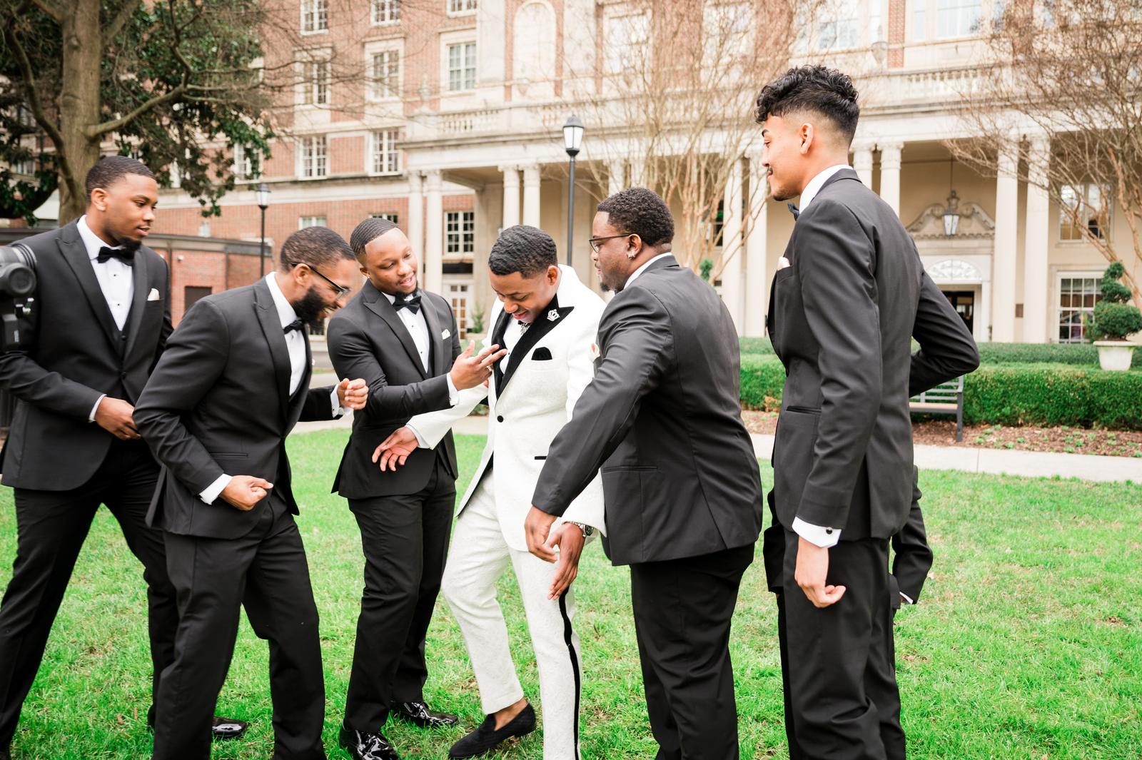 Groomsmen having fun on the lawn