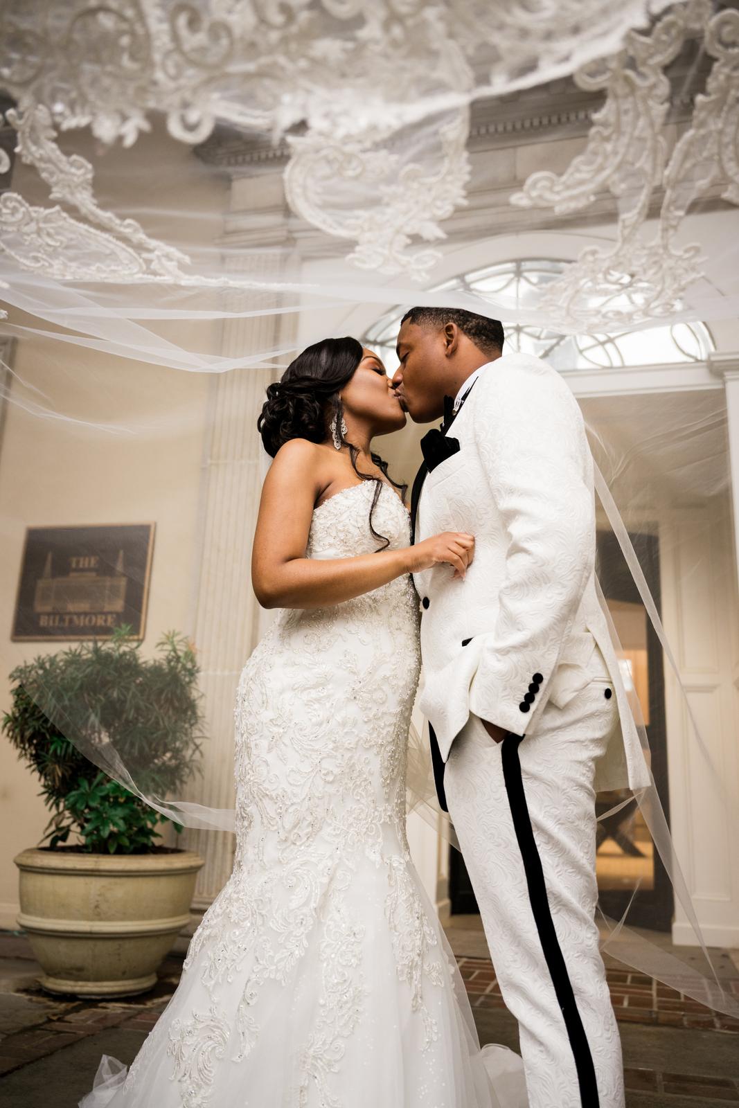 Haley and Kordel kissing under the veil