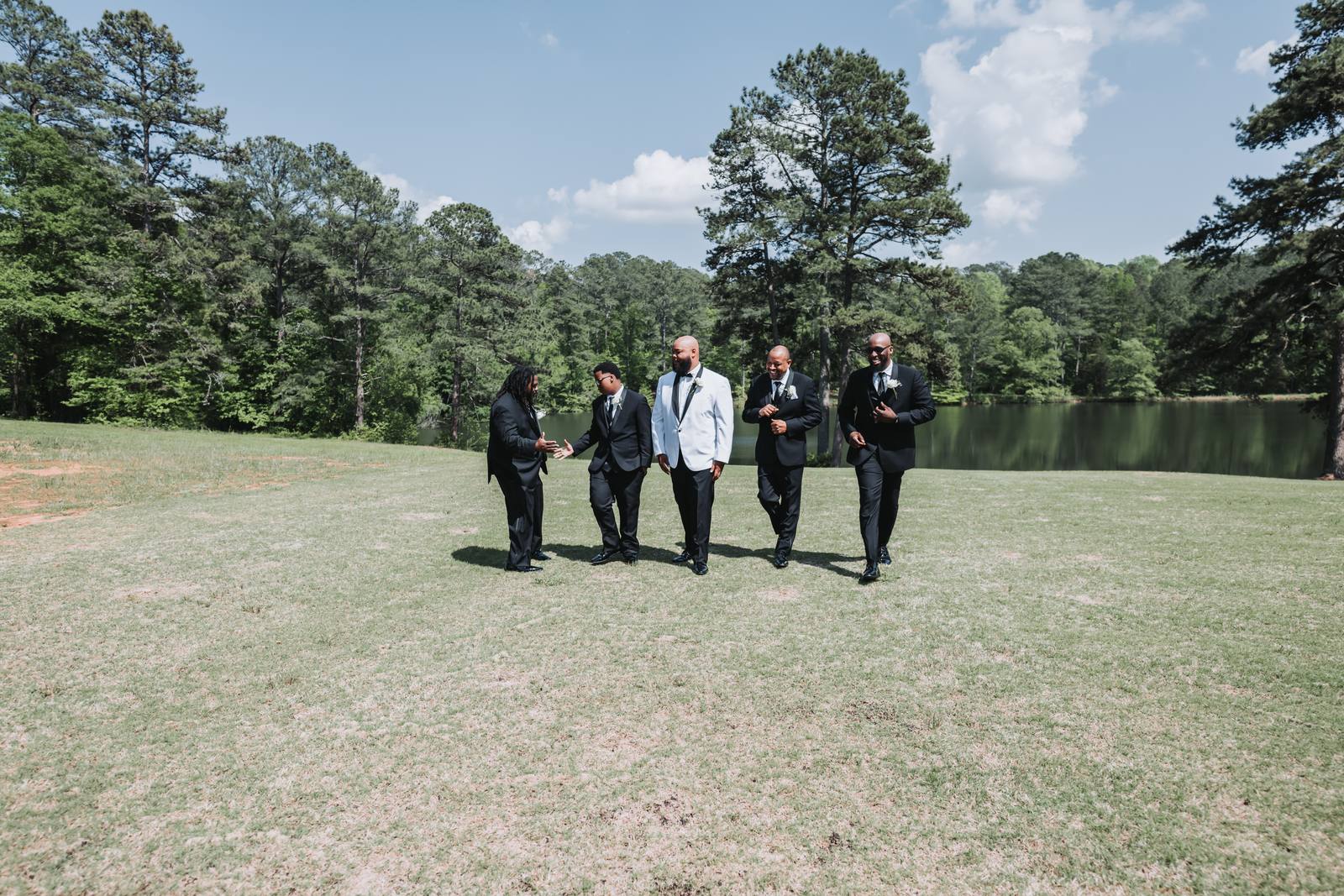 Groomsmen walking across the field