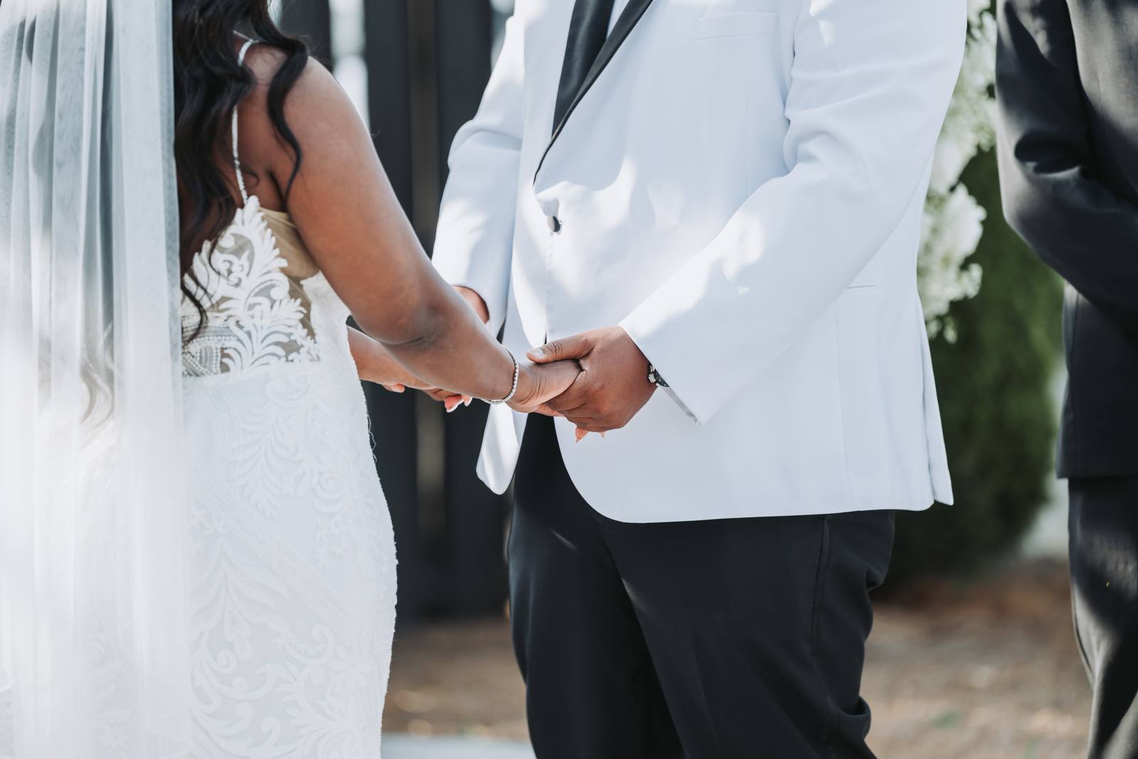 Latisha and Nate holding hands during vows