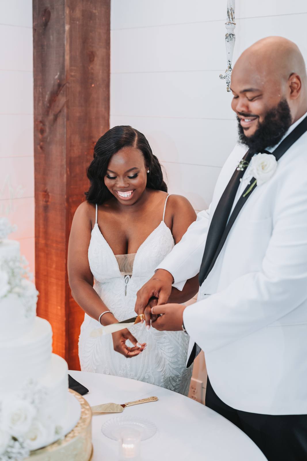 Latisha and Nate cutting the cake