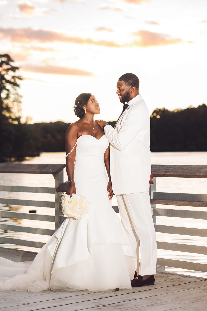 Christina and Darius backlit on the dock at sunset