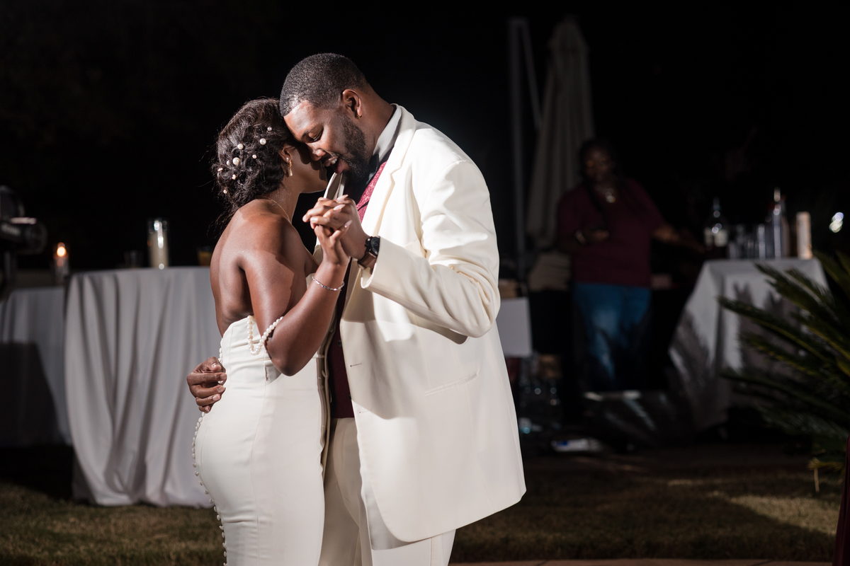 Night first dance beneath string lights