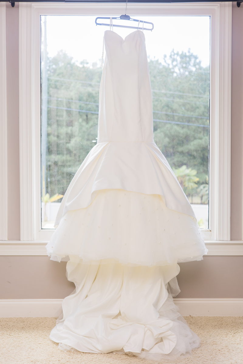 Christina's dress hanging in a backlit window