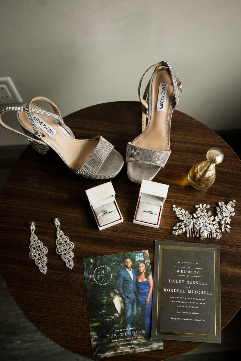 Flat lay of shoes, invitation and jewels