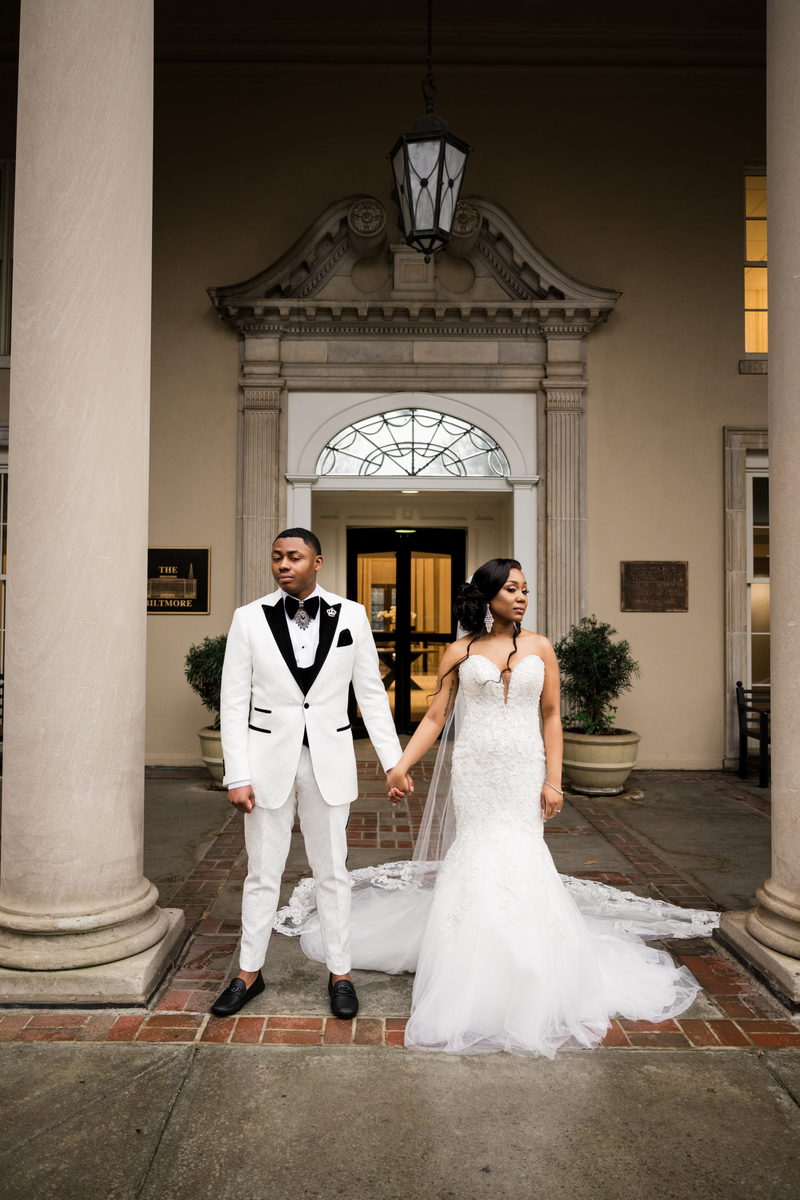Haley and Kordel hand in hand at the stone entrance