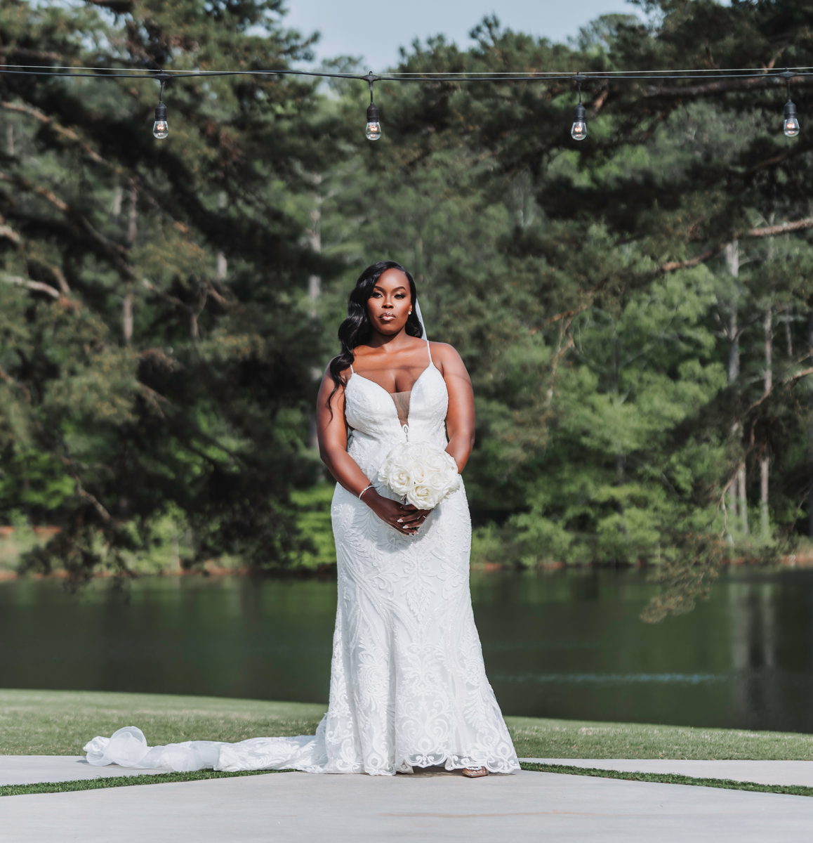 Latisha at the lake edge beneath the pines