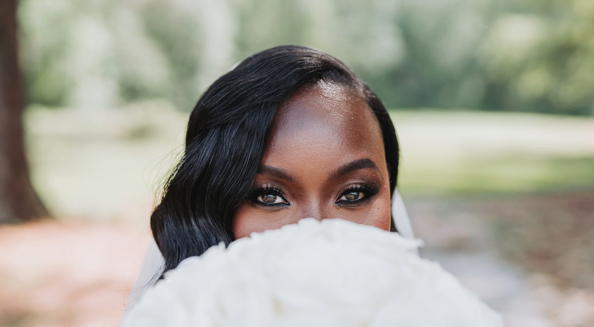 Latisha's eyes over her bouquet of white roses
