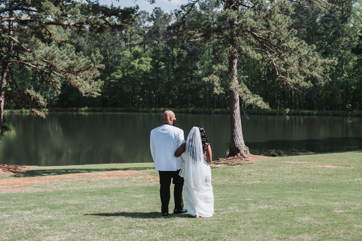 Nate and Latisha from behind at the lake, pine treeline