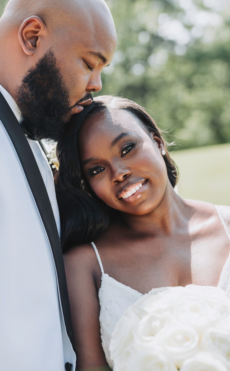 Nate kissing Latisha's forehead while she smiles to camera