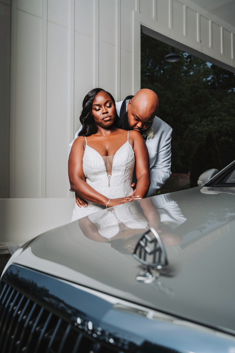 Nate and Latisha reflected in a car hood
