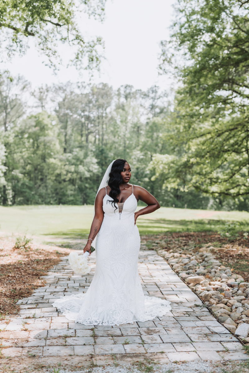 Latisha on a stone path beneath the tree canopy