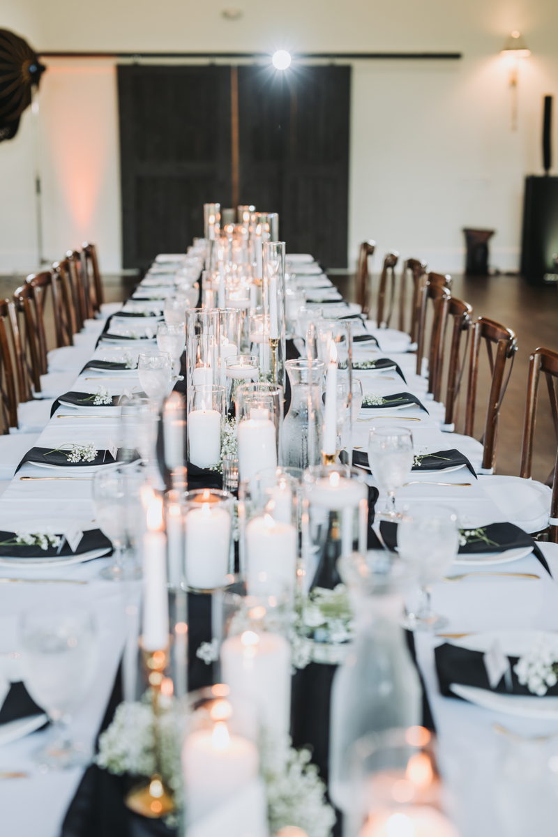 Long table with candles and a black runner