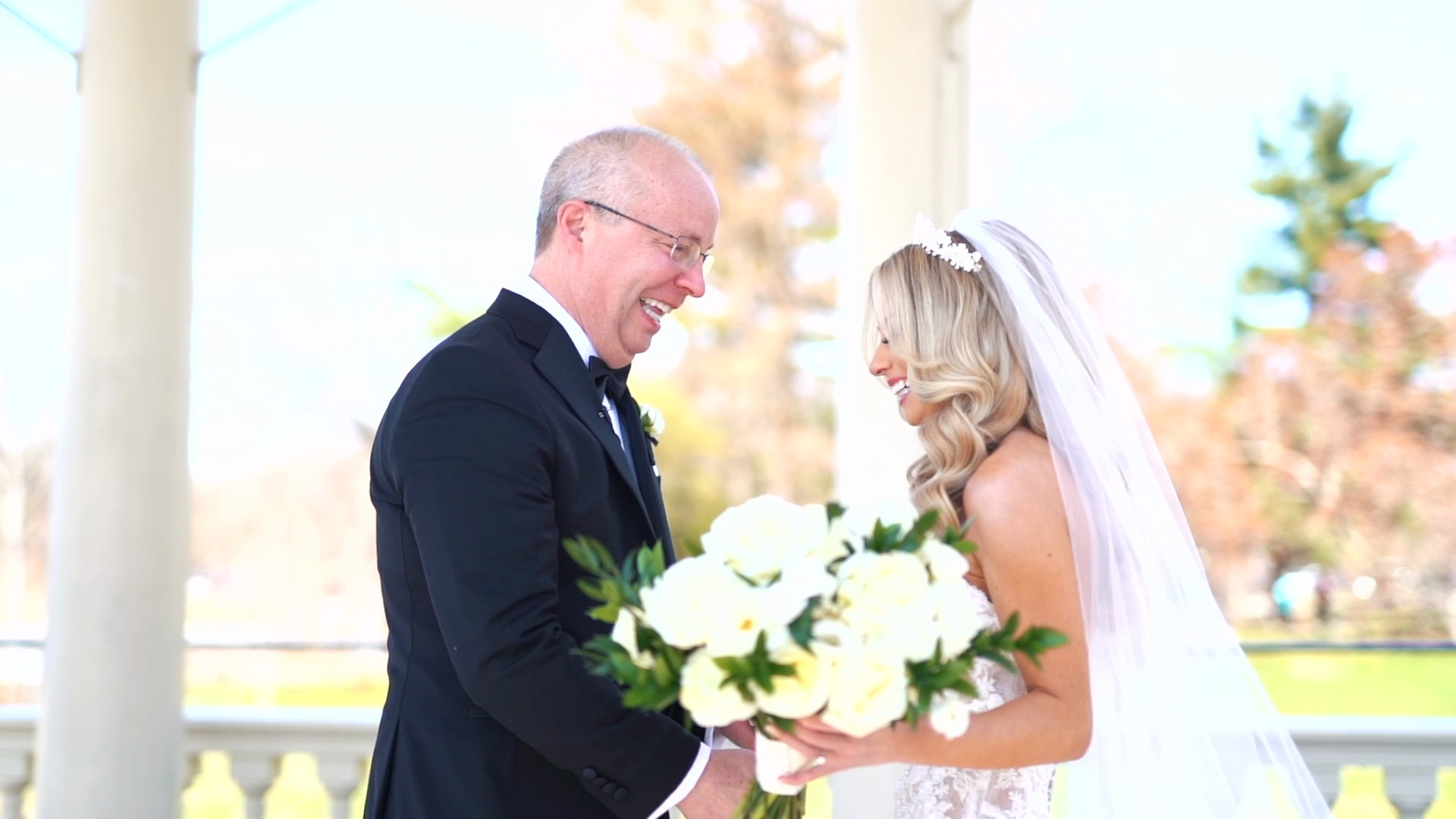 Laura and her father laughing over the bouquet