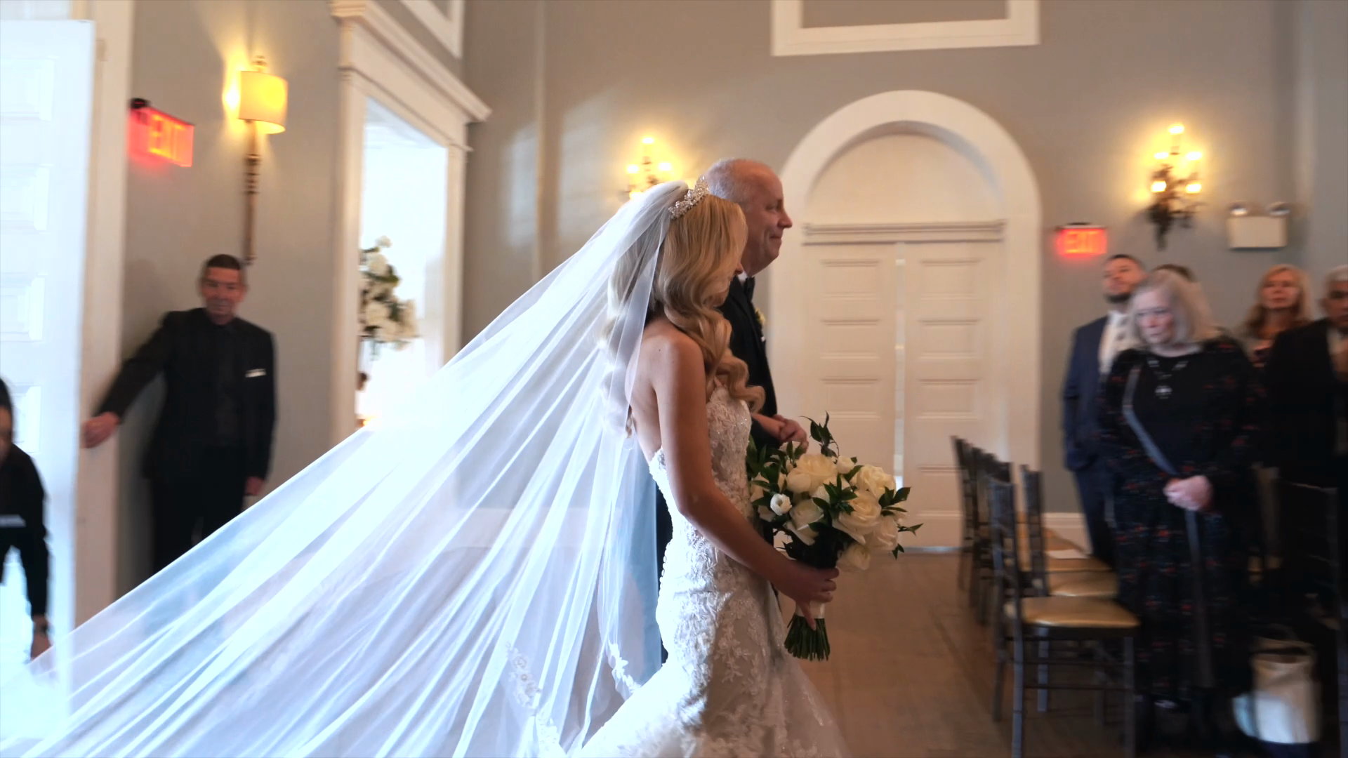 Laura walking down the aisle, veil trailing